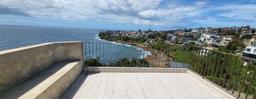 South Coogee holiday home, balcony coastal view, stone bench